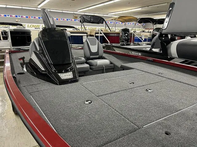 Slide: The Image of 2025 Lowe Stinger 175C boat interior with seating and storage compartments in showroom. - 4