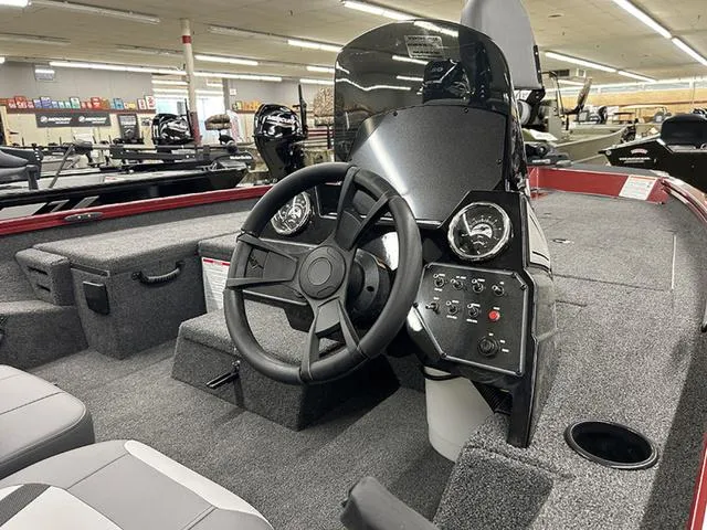 Slide: The Image of 2025 Lowe Stinger 175C boat interior with steering wheel and control panel in showroom. - 6