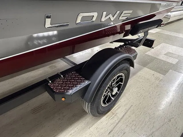 Slide: The Image of 2025 Lowe Stinger 175C boat trailer with diamond plate step and stylish wheel design. - 9