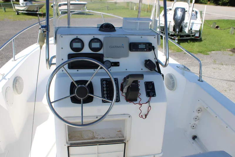Slide: The Image of 1999 Edgewater 20cc boat dashboard with steering wheel and navigation instruments. - 11