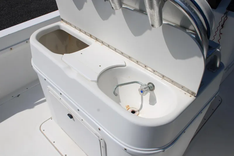 Slide: The Image of 1999 Edgewater 20cc boat console with sink and storage compartment. - 12
