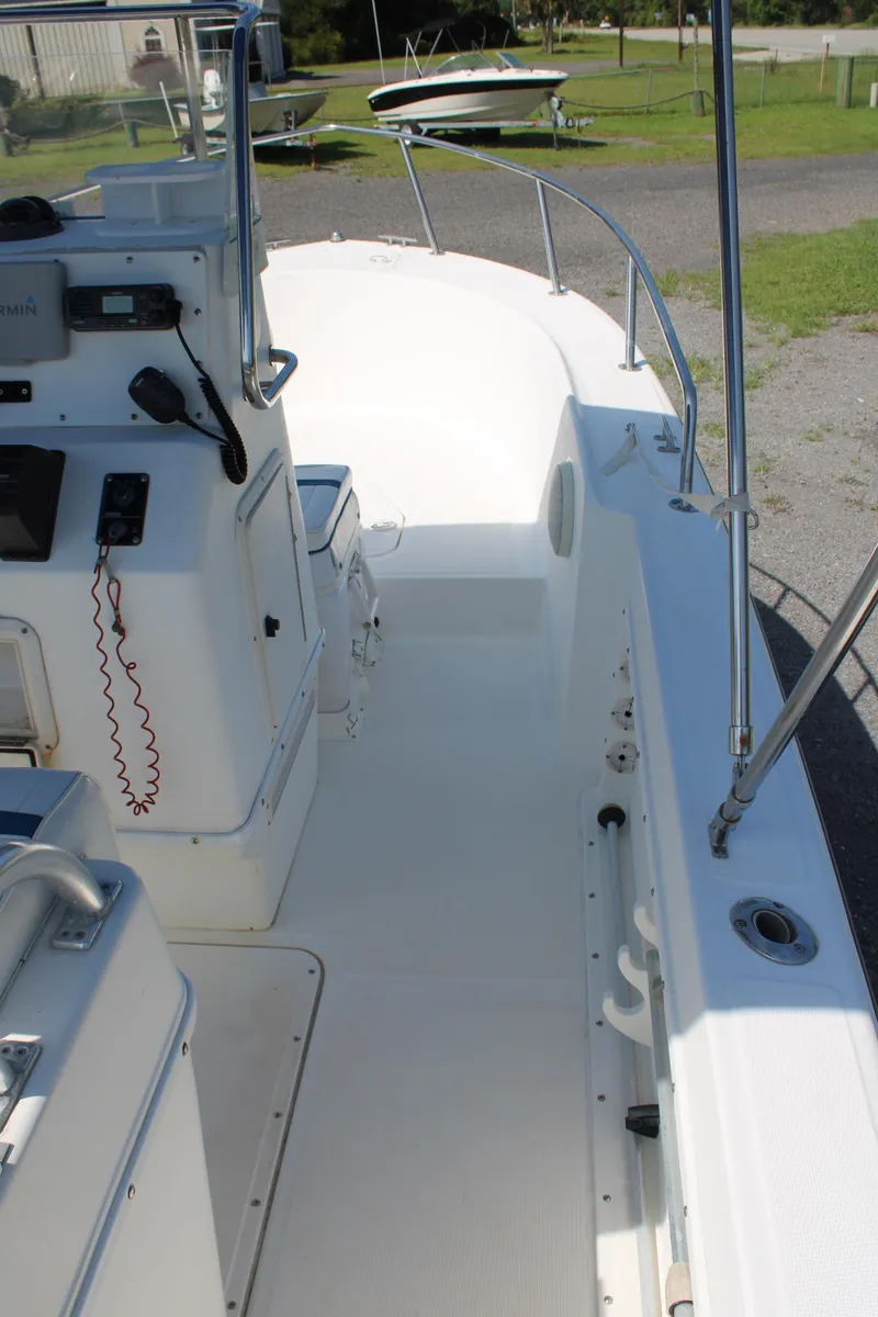 Slide: The Image of 1999 Edgewater 20cc boat interior with control panel and seating area. - 13