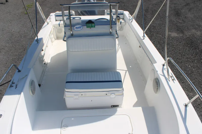 Slide: The Image of 1999 Edgewater 20cc boat interior with seating and console, showcasing clean design. - 6