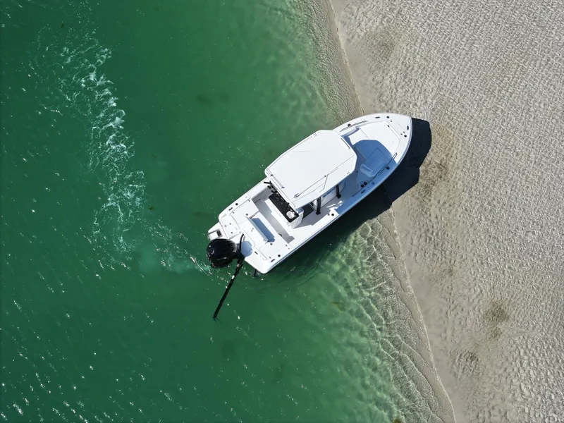 Slide: The Image of Aerial view of 2025 Crevalle 24 HCO boat on sandy shore. - 2