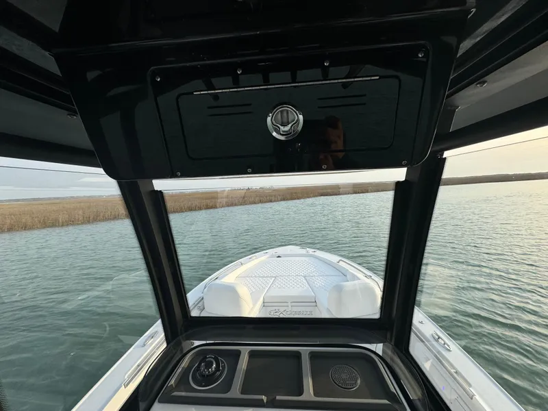 Slide: The Image of 2025 Crevalle 24 HCO boat on water, viewed from helm, showcasing sleek design. - 20