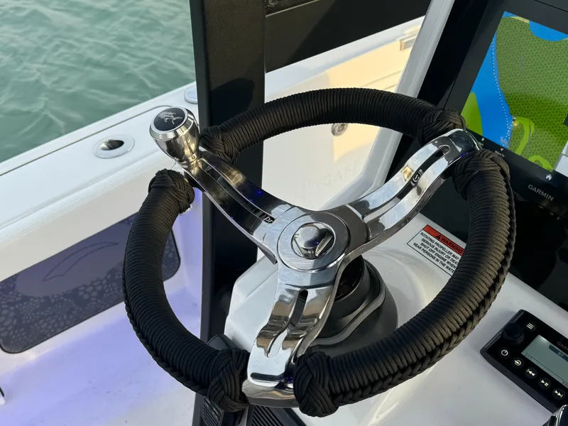 Slide: The Image of Steering wheel of 2025 Crevalle 24 HCO boat, featuring modern design and controls. - 22