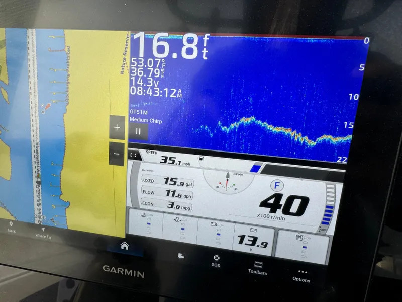 Slide: The Image of Garmin marine display showing depth, speed, and navigation data on a Crevalle 24 HCO, 2025 model. - 23