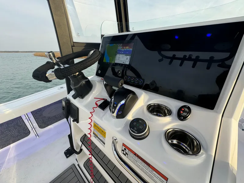 Slide: The Image of Helm of 2025 Crevalle 24 HCO boat with modern controls and navigation system. - 24