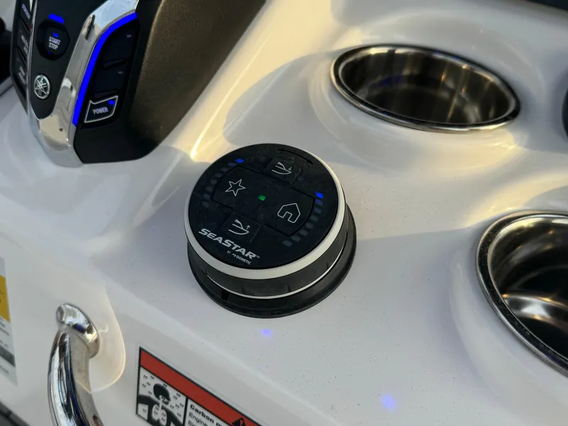 Slide: The Image of Control panel of 2025 Crevalle 24 HCO boat with SeaStar system and cup holders. - 26