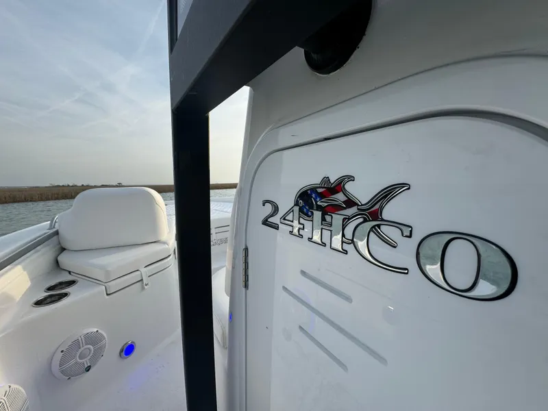 Slide: The Image of 2025 Crevalle 24 HCO boat interior with logo, white seating, and blue LED lights. - 28