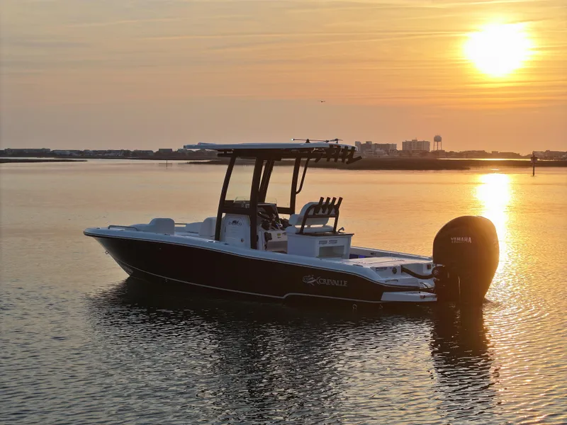 Slide: The Image of 2025 Crevalle 24 HCO boat on calm water at sunset. - 3