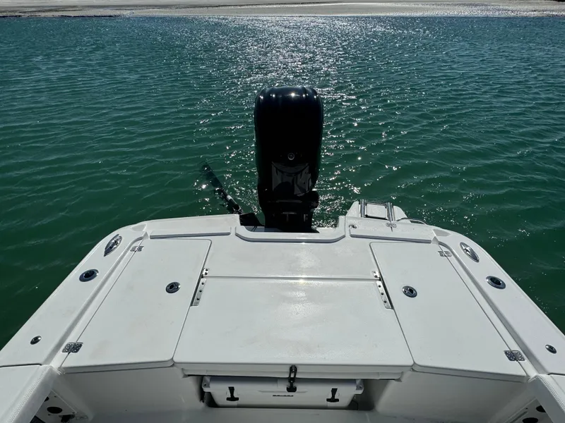 Slide: The Image of 2025 Crevalle 24 HCO boat on water, rear view with motor. - 37