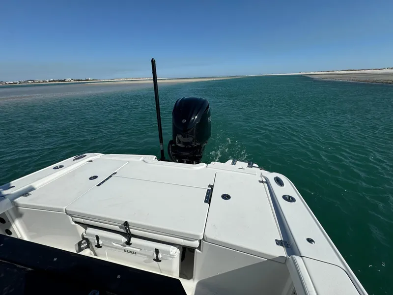 Slide: The Image of Crevalle 24 HCO 2025 boat navigating clear waters under a bright blue sky. - 38