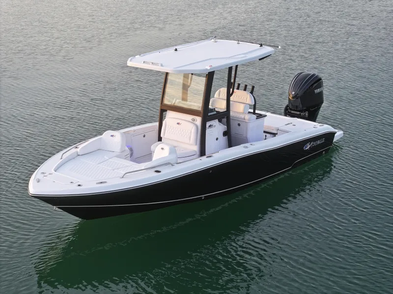Slide: The Image of 2025 Crevalle 24 HCO boat on calm water, featuring sleek design and modern outboard motor. - 4