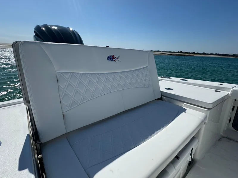 Slide: The Image of 2025 Crevalle 24 HCO boat seat with embroidered logo, set against a sunny ocean backdrop. - 40