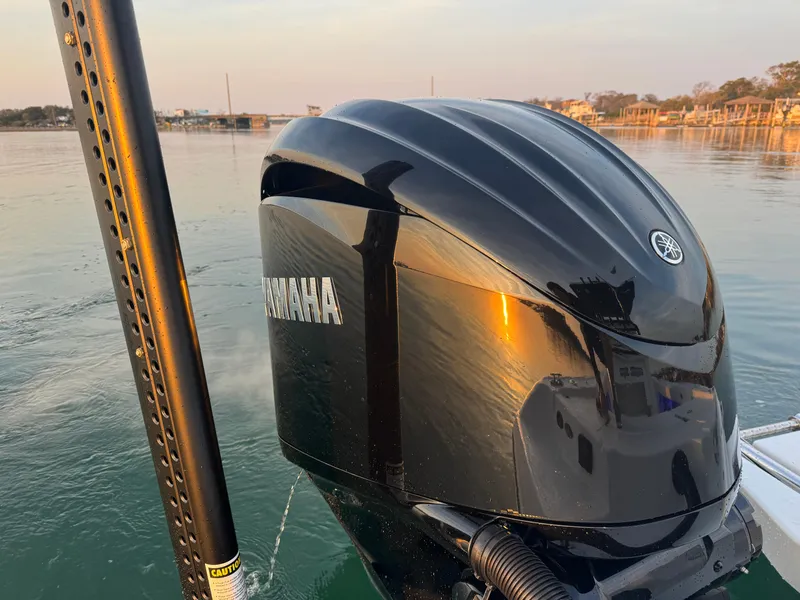 Slide: The Image of 2025 Crevalle 24 HCO with Yamaha outboard engine on calm water. - 45