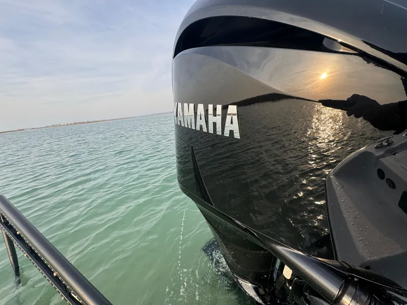 Slide: The Image of 2025 Crevalle 24 HCO boat with Yamaha engine on calm water at sunset. - 46