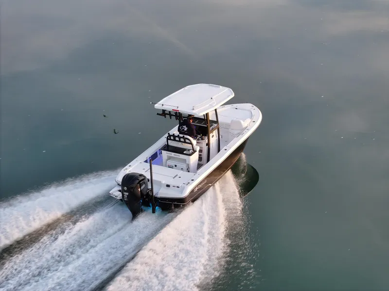 Slide: The Image of 2025 Crevalle 24 HCO boat cruising on calm water, aerial view. - 5
