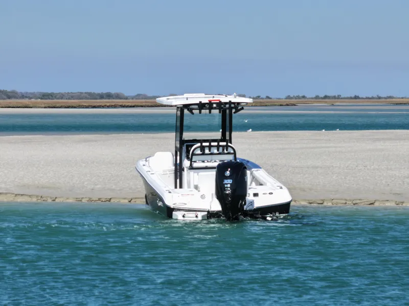 Slide: The Image of 2025 Crevalle 24 HCO boat anchored on sandy shore with clear blue water. - 6