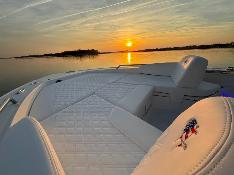 Slide: The Image of 2025 Crevalle 24 HCO boat interior at sunset on calm water. - 7