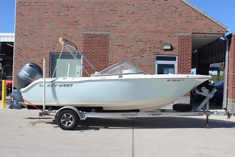 Slide: The Image of 2020 Key West 203 DFS boat on trailer, parked near brick building. - 0