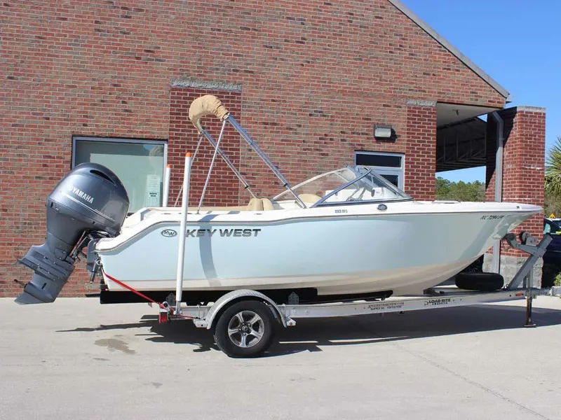Slide: The Image of 2020 Key West 203 DFS boat on trailer, parked outside brick building. - 1