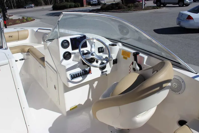 Slide: The Image of 2020 Key West 203 DFS boat interior with steering wheel and seating. - 11