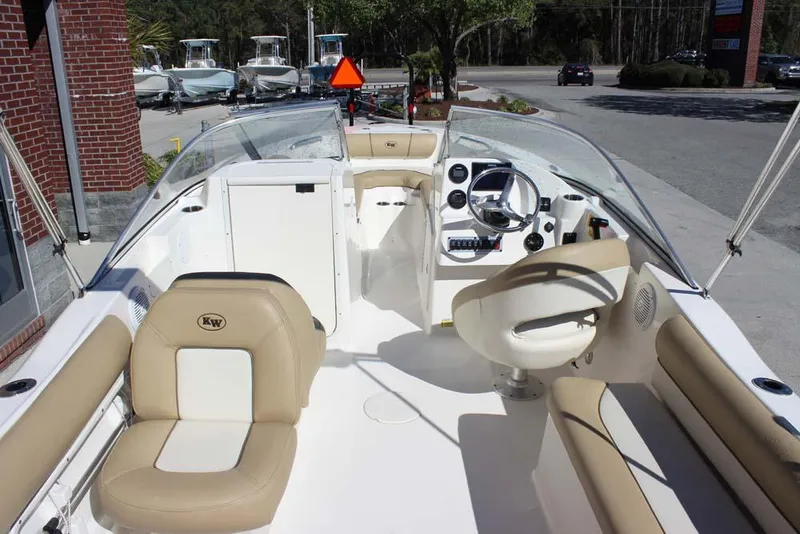 Slide: The Image of 2020 Key West 203 DFS boat interior with beige seating and steering console. - 16