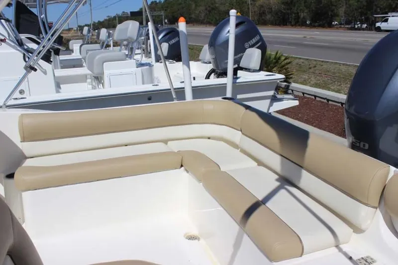 Slide: The Image of Key West 203 DFS 2020 boat with beige seating and Yamaha engines in a marina setting. - 17