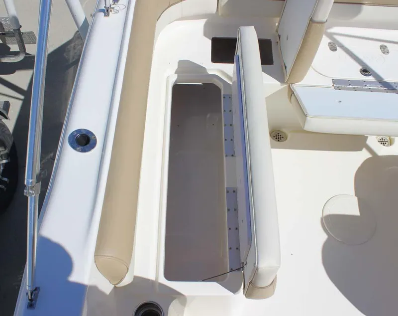 Slide: The Image of Key West 203 DFS 2020 boat interior with open storage compartment and beige seating. - 20