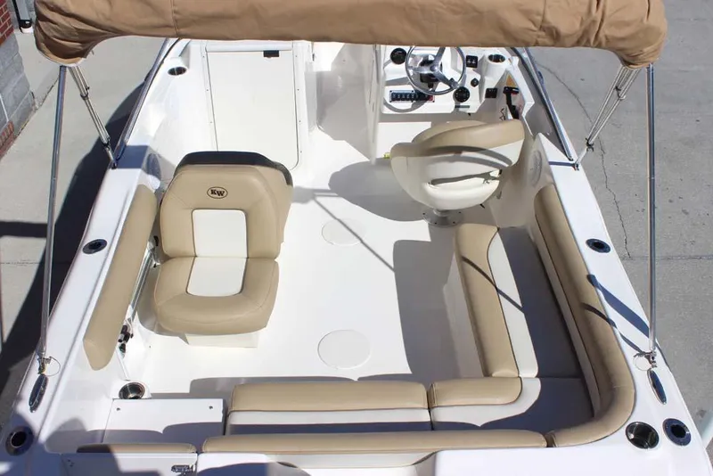 Slide: The Image of 2020 Key West 203 DFS boat interior with beige seating and steering console. - 5