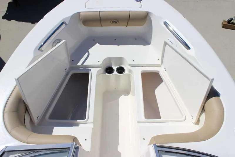 Slide: The Image of 2020 Key West 203 DFS boat interior with open storage compartments and cup holders. - 8