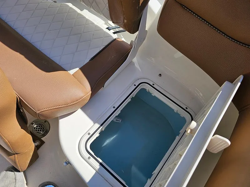 Slide: The Image of 2023 Pioneer 202 Islander boat interior with open storage compartment and brown seating. - 11