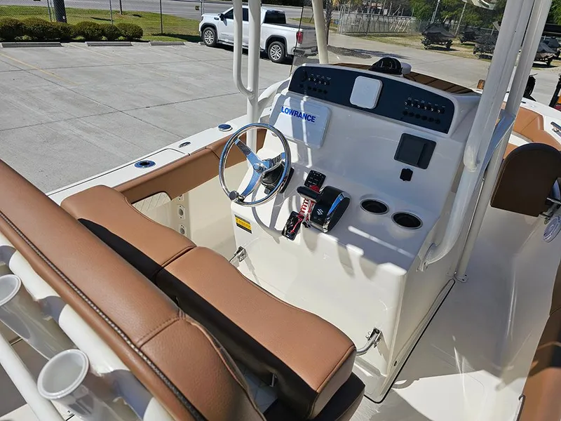 Slide: The Image of 2023 Pioneer 202 Islander boat console with steering wheel and controls. - 12