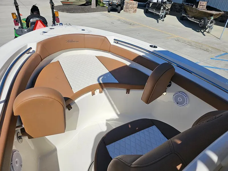 Slide: The Image of 2023 Pioneer 202 Islander boat interior with brown and white seating, outdoor setting. - 17