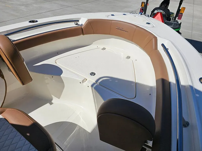Slide: The Image of 2023 Pioneer 202 Islander boat interior with brown seating and white deck. - 18