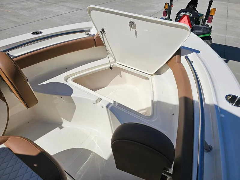 Slide: The Image of 2023 Pioneer 202 Islander boat with open storage compartment and brown seating. - 19