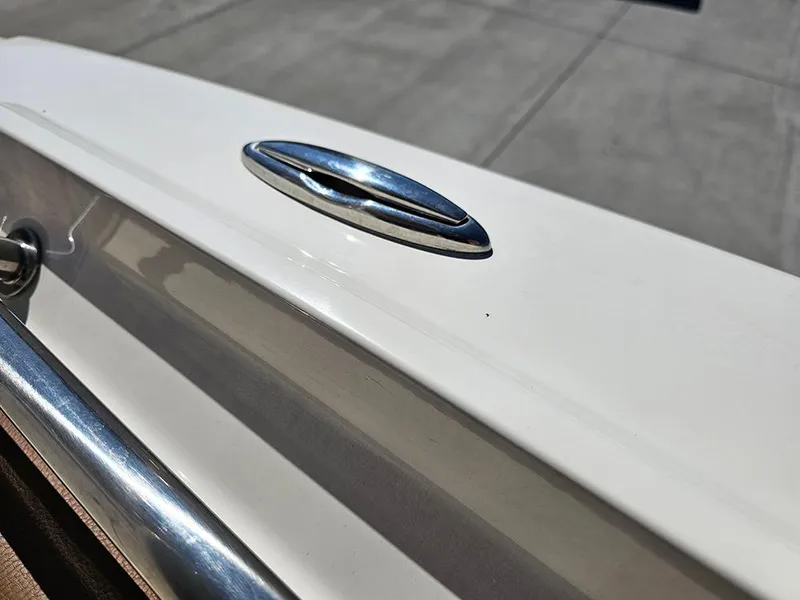 Slide: The Image of 2023 Pioneer 202 Islander boat detail, featuring sleek white surface and chrome accents. - 20