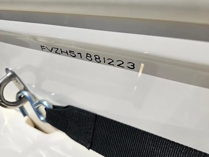 Slide: The Image of 2023 Pioneer 202 Islander boat with visible serial number and securing strap. - 22