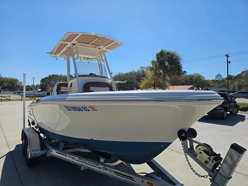 Slide: The Image of 2023 Pioneer 202 Islander boat on trailer, sunny day, palm tree in background. - 5