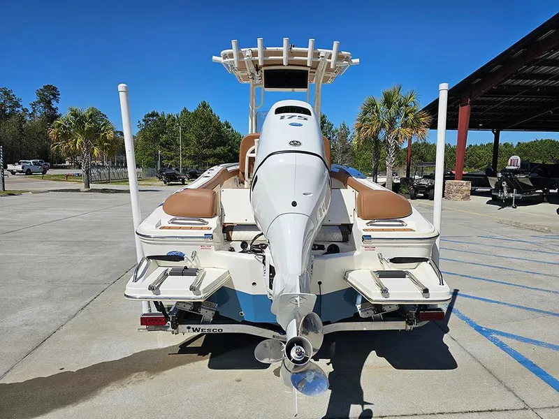 Slide: The Image of 2023 Pioneer 202 Islander boat, rear view, parked outdoors on a sunny day. - 8