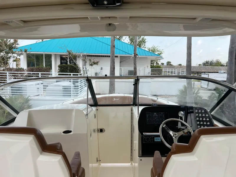 Slide: The Image of 2018 Scout 255 Dorado boat interior with dual seats and control panel. - 14