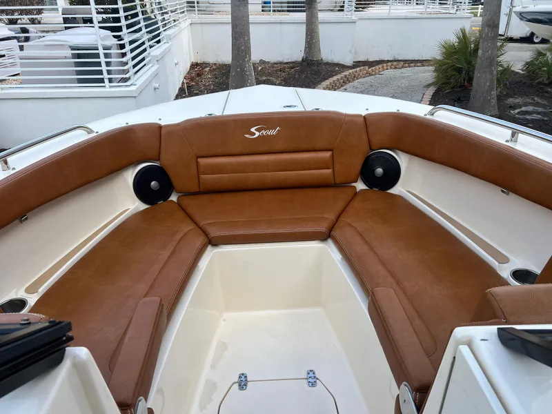 Slide: The Image of 2018 Scout 255 Dorado boat interior with brown leather seating and built-in speakers. - 15