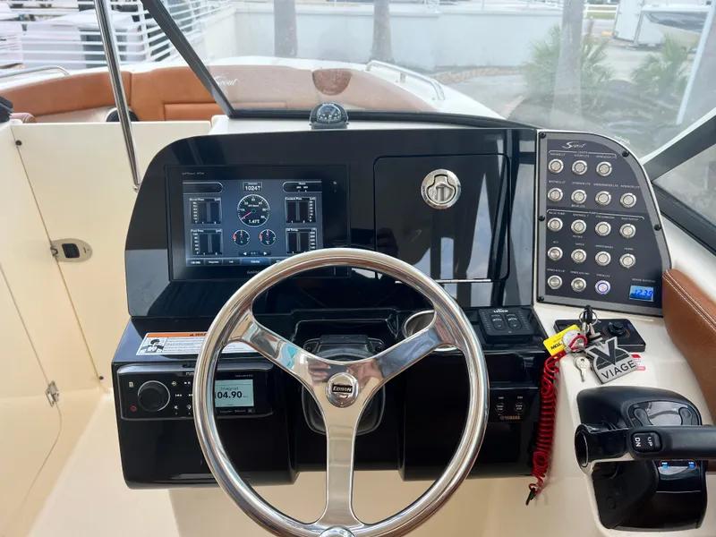 Slide: The Image of Helm of 2018 Scout 255 Dorado boat with steering wheel and control panel. - 16