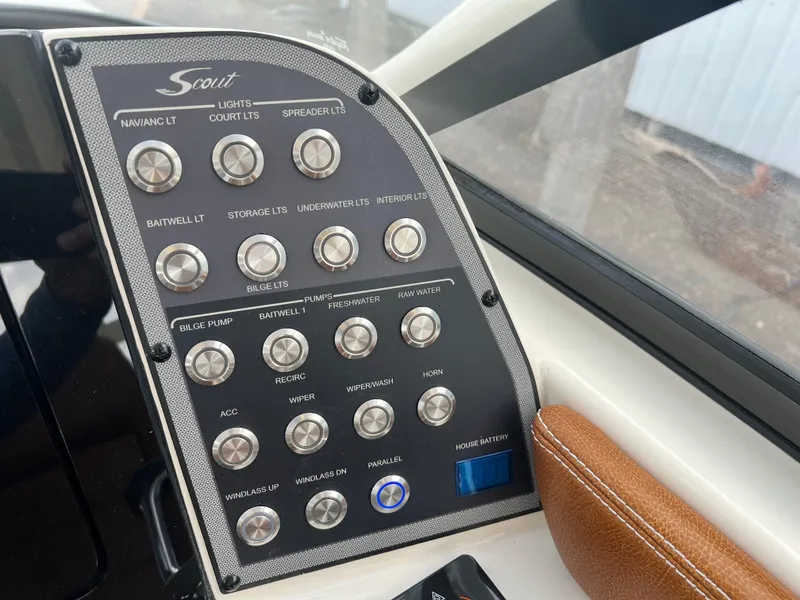 Slide: The Image of Control panel of 2018 Scout 255 Dorado boat with labeled switches and buttons. - 17