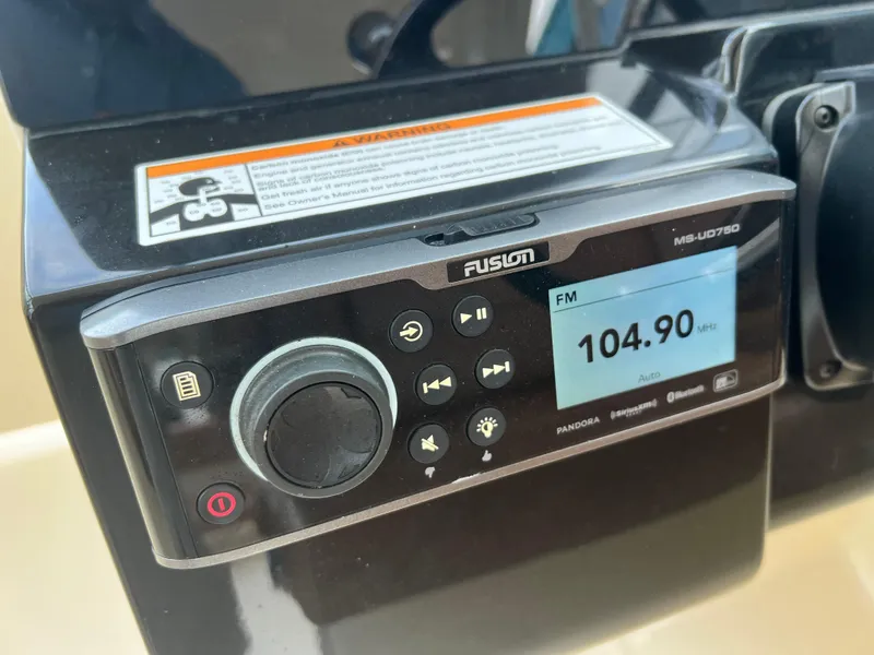 Slide: The Image of Fusion marine stereo on a 2018 Scout 255 Dorado, displaying FM 104.90 MHz. - 21