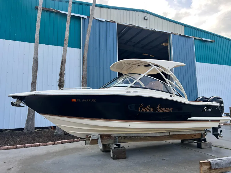 Slide: The Image of 2018 Scout 255 Dorado boat named "Endless Summer" on display outside a blue and white building. - 23