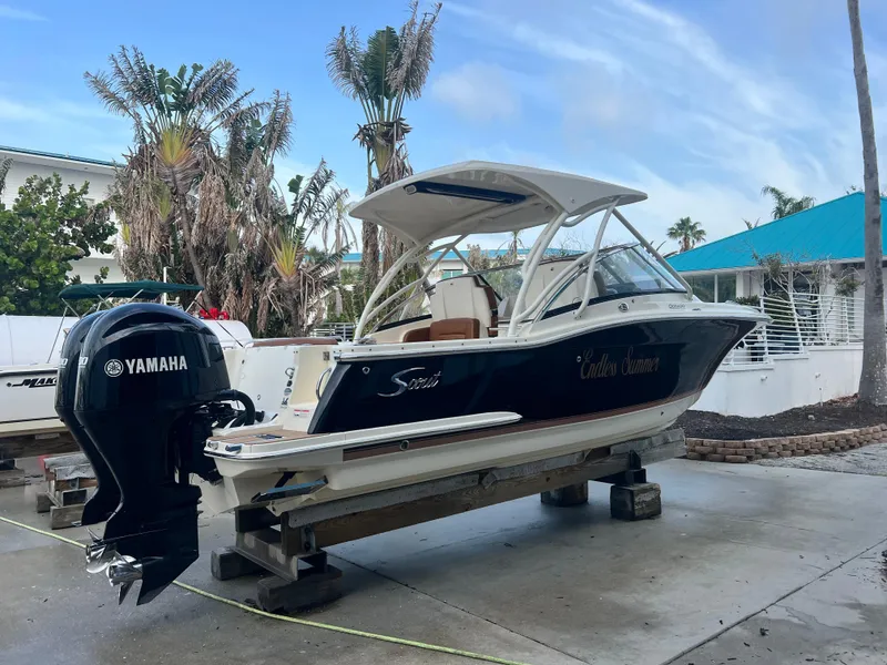 Slide: The Image of 2018 Scout 255 Dorado boat with Yamaha engine on a dock. - 4