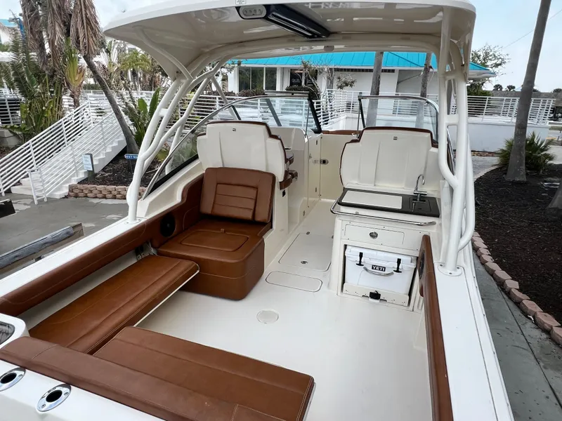 Slide: The Image of 2018 Scout 255 Dorado boat interior with brown seating and white deck. - 5