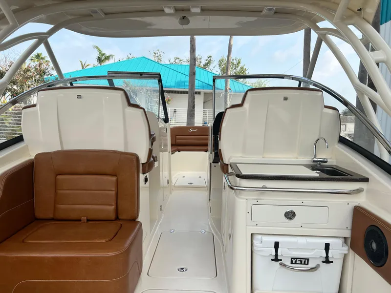 Slide: The Image of 2018 Scout 255 Dorado boat interior with seating, sink, and Yeti cooler. - 8